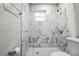 Updated bathroom with marble-look shower and window at 1913 Nw 12Th St, Ocala, FL 34475