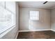 Well-lit bedroom with wood-look floors and a large window at 1913 Nw 12Th St, Ocala, FL 34475