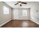 Spacious bedroom with wood-look floors, ceiling fan, and exterior access at 1913 Nw 12Th St, Ocala, FL 34475