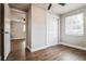 Bedroom with wood-look floors, ceiling fan, and access to another room at 1913 Nw 12Th St, Ocala, FL 34475