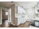 White kitchen features stainless steel appliances and wood flooring at 1913 Nw 12Th St, Ocala, FL 34475