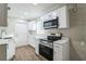 Modern kitchen with white cabinets, stainless steel appliances, and quartz countertops at 1913 Nw 12Th St, Ocala, FL 34475