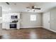 Living room with hardwood floors, ceiling fan, and access to other rooms at 1913 Nw 12Th St, Ocala, FL 34475