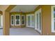 View of covered porch that enhances indoor-outdoor living with access to the backyard and natural light at 1943 Sipes Ave, Sanford, FL 32771