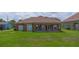 Expansive backyard with a covered patio, providing a serene outdoor space with a lawn at 1943 Sipes Ave, Sanford, FL 32771