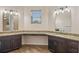 Double vanity bathroom with granite countertops and large mirrors at 1943 Sipes Ave, Sanford, FL 32771