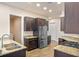 Modern kitchen with dark cabinets, granite counters, and stainless steel appliances at 1943 Sipes Ave, Sanford, FL 32771