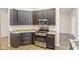 Modern kitchen with dark cabinets, granite countertops, and stainless steel appliances at 1943 Sipes Ave, Sanford, FL 32771