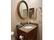 Bathroom with granite vanity, an oval mirror, and a medicine cabinet at 2465 Grand Teton Cir # 2465, Winter Park, FL 32792