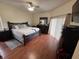 Cozy bedroom with a ceiling fan, a large bed, and hardwood floors at 2739 Star Grass Cir, Kissimmee, FL 34746