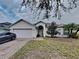 Single-story house with attached garage and landscaped lawn at 2739 Star Grass Cir, Kissimmee, FL 34746