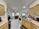 Kitchen with light wood cabinets, ample counter space, and a breakfast bar at 2739 Star Grass Cir, Kissimmee, FL 34746