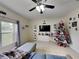 Living room with sectional sofa, Christmas tree, and large window at 2739 Star Grass Cir, Kissimmee, FL 34746