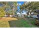 Spacious backyard with green grass and trees at 3251 Brewster Dr, Kissimmee, FL 34743