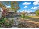 Landscaped backyard with patio and grassy area at 3251 Brewster Dr, Kissimmee, FL 34743