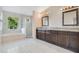 Elegant bathroom with double vanity, granite countertop, and large walk-in shower at 3251 Brewster Dr, Kissimmee, FL 34743