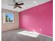 Bedroom with pink accent wall, ceiling fan, and a window at 3251 Brewster Dr, Kissimmee, FL 34743