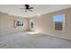 Spacious bedroom with neutral walls and carpet, featuring multiple windows and ceiling fan at 3251 Brewster Dr, Kissimmee, FL 34743