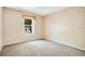 Well-lit bedroom with a window and neutral colored carpet at 3251 Brewster Dr, Kissimmee, FL 34743