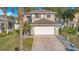 Two-story house with a white garage door and stone accents at 3251 Brewster Dr, Kissimmee, FL 34743