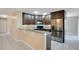 Modern kitchen with dark brown cabinets and granite countertops at 3251 Brewster Dr, Kissimmee, FL 34743