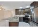 Modern kitchen with dark brown cabinets and granite countertops at 3251 Brewster Dr, Kissimmee, FL 34743