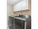 Laundry room with stacked washer and dryer, and white cabinets at 3251 Brewster Dr, Kissimmee, FL 34743