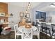 Bright dining area with white table and chairs, adjacent to the kitchen at 3401 Shallot Dr # 103, Orlando, FL 32835