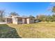 Tan house with a large backyard and trees at 421 Jefferson St, Daytona Beach, FL 32114