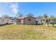 Tan house with a large grassy yard and other houses at 421 Jefferson St, Daytona Beach, FL 32114