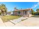 Front view of a charming tan house with a unique tiled walkway at 421 Jefferson St, Daytona Beach, FL 32114