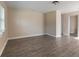 Spacious living room with wood-look floors and neutral walls at 421 Jefferson St, Daytona Beach, FL 32114