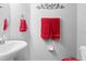 Clean bathroom with white sink and red towels at 4847 Havilland Dr, Mount Dora, FL 32757