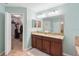 Double vanity with granite countertop and walk-in closet at 4847 Havilland Dr, Mount Dora, FL 32757