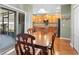 Bright dining room features wood flooring and a view to the kitchen at 4847 Havilland Dr, Mount Dora, FL 32757