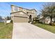 Two-story house with a large driveway and landscaped yard at 4847 Havilland Dr, Mount Dora, FL 32757