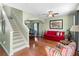 Spacious living room with hardwood floors, a staircase, and a dining area at 4847 Havilland Dr, Mount Dora, FL 32757