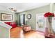Living room with hardwood floors, red couch, and access to backyard at 4847 Havilland Dr, Mount Dora, FL 32757