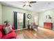 Living room with hardwood floors, red couch, and access to backyard at 4847 Havilland Dr, Mount Dora, FL 32757