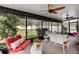 Relaxing screened porch with white wicker furniture and ceiling fans at 4847 Havilland Dr, Mount Dora, FL 32757