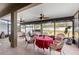Enjoy this screened porch with red accents and ceiling fans at 4847 Havilland Dr, Mount Dora, FL 32757