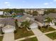 Two-story house with beige exterior and two-car garage at 8106 Fan Palm Way, Kissimmee, FL 34747