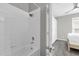Clean bathroom with a shower/tub combo and grey walls at 8106 Fan Palm Way, Kissimmee, FL 34747