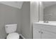 Simple half bathroom with vanity and toilet at 8106 Fan Palm Way, Kissimmee, FL 34747