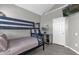 Bedroom with a bunk bed, gray walls and wood floor at 8106 Fan Palm Way, Kissimmee, FL 34747