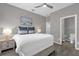 Bright bedroom with ensuite bathroom and wood-look floors at 8106 Fan Palm Way, Kissimmee, FL 34747