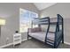 Bedroom with a bunk bed and large window at 8106 Fan Palm Way, Kissimmee, FL 34747