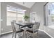 Bright dining area with a four-person table and windows at 8106 Fan Palm Way, Kissimmee, FL 34747