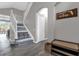 Bright entryway with tile flooring, bench, and stairs with mosaic detail at 8106 Fan Palm Way, Kissimmee, FL 34747