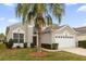 Beautiful two-story home with a two-car garage and palm trees at 8106 Fan Palm Way, Kissimmee, FL 34747